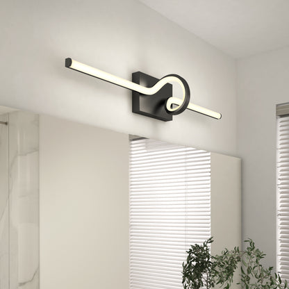 The Artika Bowtie modern LED bathroom vanity light 5 CCT, featuring a rectangular black base and a long bent tube design, is installed above a large mirror near a window with blinds and a green plant in the corner.