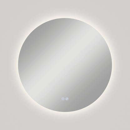 The Artika-CAN-dev Raya 24 in. LED mirror features a round, wall-mounted design with a halo-effect backlight, two touch controls at the bottom center, and a built-in defogger, pictured against a plain light gray wall.