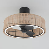 A ceiling fan with black blades is enclosed in a round, woven rattan shade with a built-in circular LED light, set against a plain white ceiling.