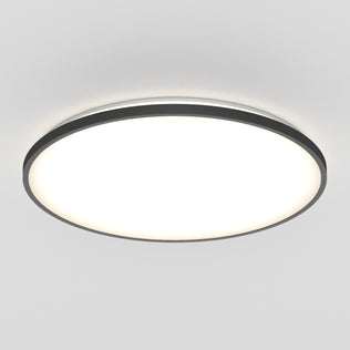 The Artika Europa 21 in. LED modern flush mount light features a black rim and bright diffused white center, blending seamlessly with a plain white ceiling; includes remote control for convenience.