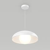A modern, dome-shaped white pendant light hangs from the ceiling, with a glowing bulb illuminating the inside of the smooth, curved shade against a plain gray background.