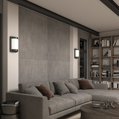 Modern living room with a gray sectional, cushions, round wood coffee table, built-in bookshelves, and Artikas Fogo modern LED indoor-outdoor wall lights on a large gray accent wall.