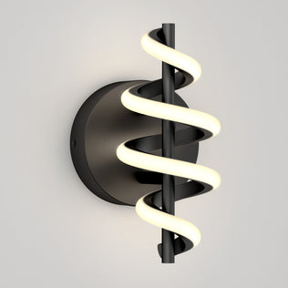 The Chorus LED Wall Light by Artika features a black circular base and a vertical rod wrapped in a glowing spiral LED, shown mounted on a plain light gray wall.
