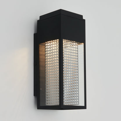 The Meteor LED indoor/outdoor wall light by Artika-CAN-dev features a modern black design with clear glass panels and perforated metal interior, mounted on a white wall and emitting soft, warm light.