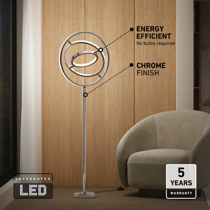 The Artika Pivot modern LED floor lamp 3 CCT, featuring energy-efficient integrated LEDs and a chrome finish, stands by a beige armchair. Text highlights its chrome look and 5-year warranty.