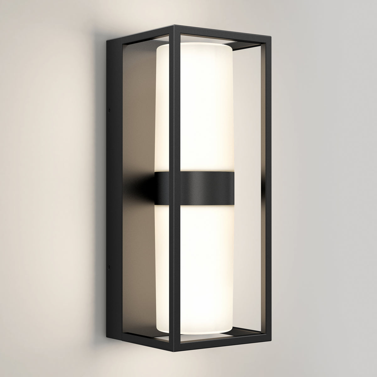 A modern wall sconce light with a rectangular black metal frame and a cylindrical white frosted glass shade, mounted on a light-colored wall.