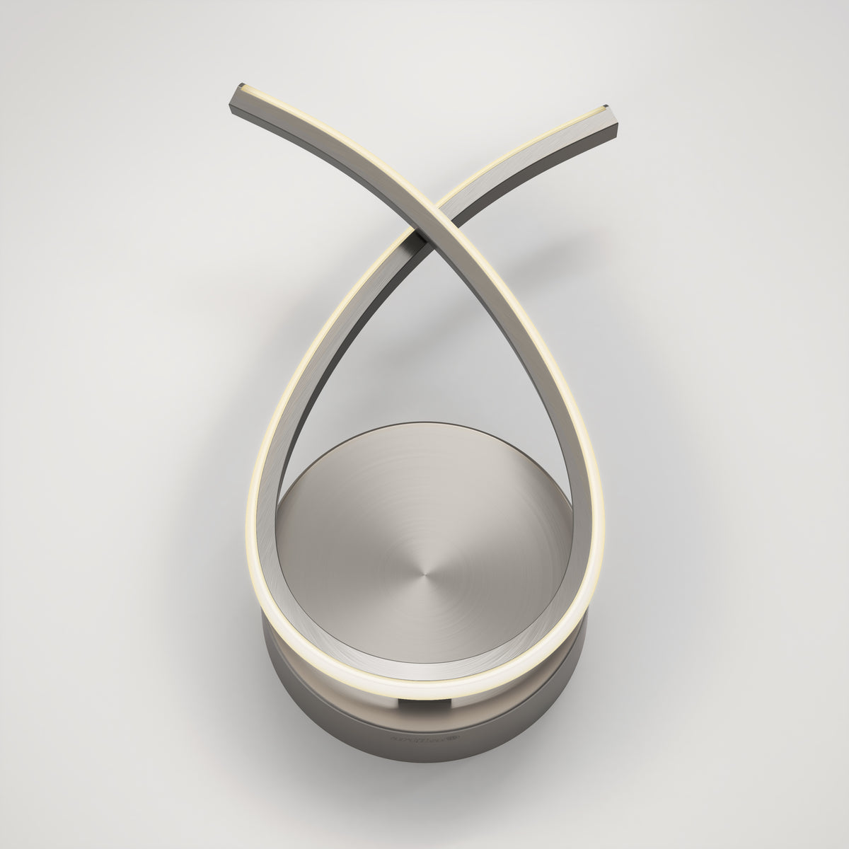 A modern, sculptural LED table lamp with two curved, intersecting metal arms forming an elegant loop above a circular base, set against a white background.