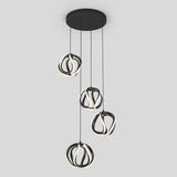 A modern ceiling pendant light with four black, looped LED fixtures hanging at different lengths from a round black base against a plain light gray background.