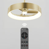 Modern gold ceiling fan with a circular LED light fixture, shown with a black remote control and a wireless signal icon indicating remote operation. The background is plain and light-colored.