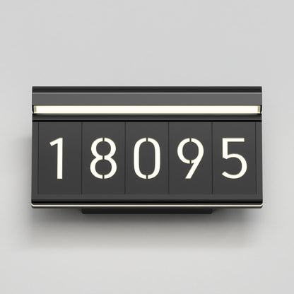 A modern black house number sign displays the numbers “18095” in large, illuminated white digits against a light gray background.