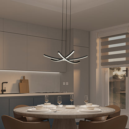 A modern kitchen with beige cabinets and a round dining table set with dishes and glasses features the Artika Orly modern LED pendant light 5 CCT as a sculptural centerpiece above. Sunlight streams in through striped blinds.