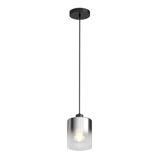 The Artika Haze pendant light glass features a sleek black ceiling mount, a long black cord, and a cylindrical clear glass shade that showcases the glowing bulb inside.