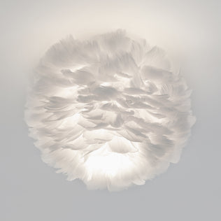 The Artika Plume LED flush mount light features a round design covered in soft white feathers, offering gentle, cloud-like illumination.