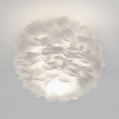 The Artika Plume LED flush mount light features a round design covered in soft white feathers, offering gentle, cloud-like illumination.