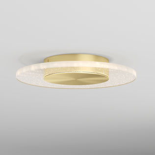 The Artika Essence Disk LED flush mount is a modern, round gold ceiling light featuring a flat circular base and a glowing translucent ring, elegantly installed on a white ceiling.