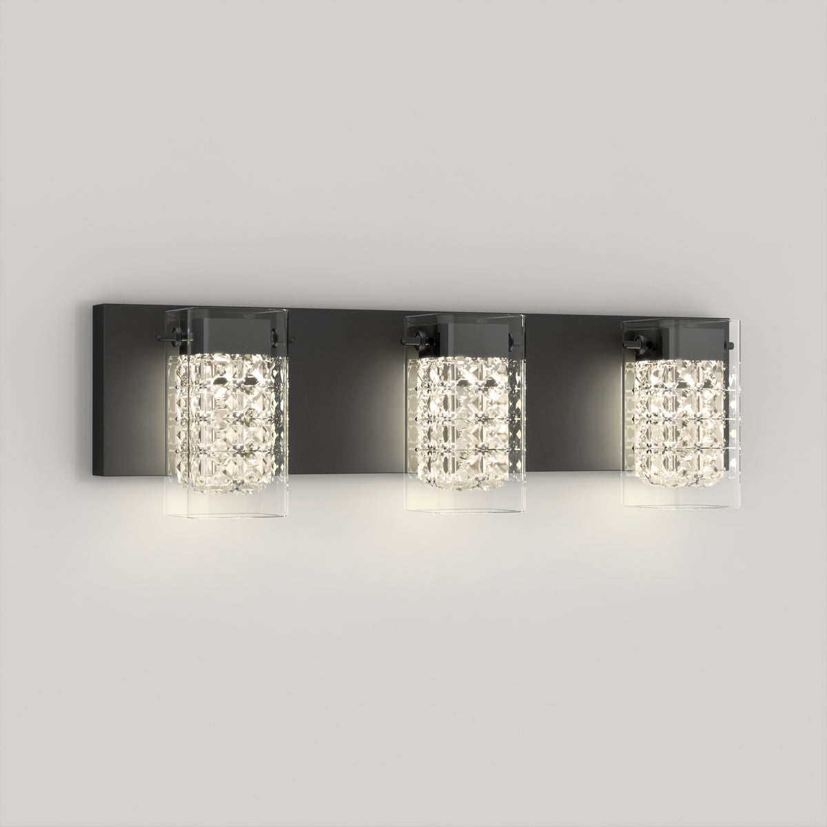 The Artika Crystal Cube LED bathroom vanity light features three glass shades with crystal-like patterns, mounted on a rectangular dark metal base, adding a modern touch to any light gray wall.