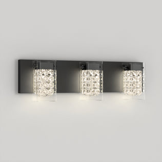 The Artika Crystal Cube LED bathroom vanity light features three glass shades with crystal-like patterns, mounted on a rectangular dark metal base, adding a modern touch to any light gray wall.
