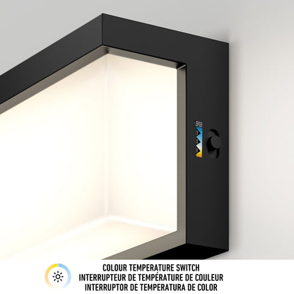 Close-up of the Artika Bristol modern LED bathroom vanity light 3 CCT, featuring a visible color temperature switch with indicator labels, mounted on a white wall. Text below: Colour Temperature Switch in three languages.