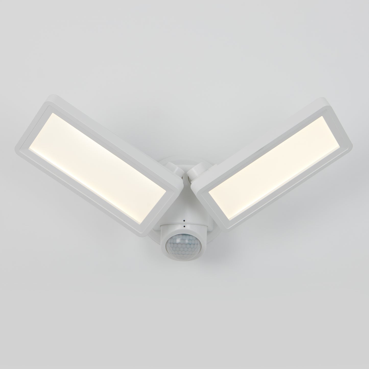 The Artika Sentinel outdoor Flat Panel Security Light features a modern white wall-mounted design with two adjustable rectangular LED panels and a central motion sensor, shown against a plain white background.
