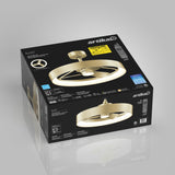 A black box with a gold Artika Austir ceiling fan and LED light fixture is shown. The box displays product details, images, and specifications, with the fan’s modern design clearly visible on the packaging.