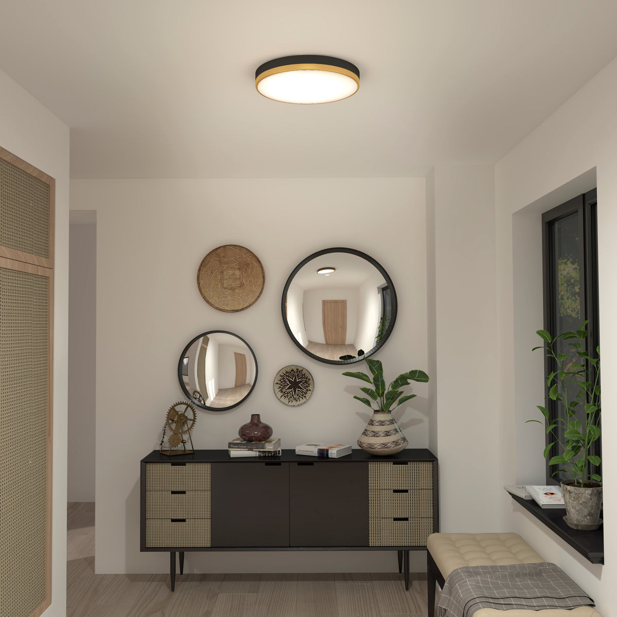 A modern hallway with a black and beige cabinet, three round mirrors above it, decorative vases and plants, a woven basket on the wall, and a cushioned bench near a window. A ceiling light softly illuminates the space.