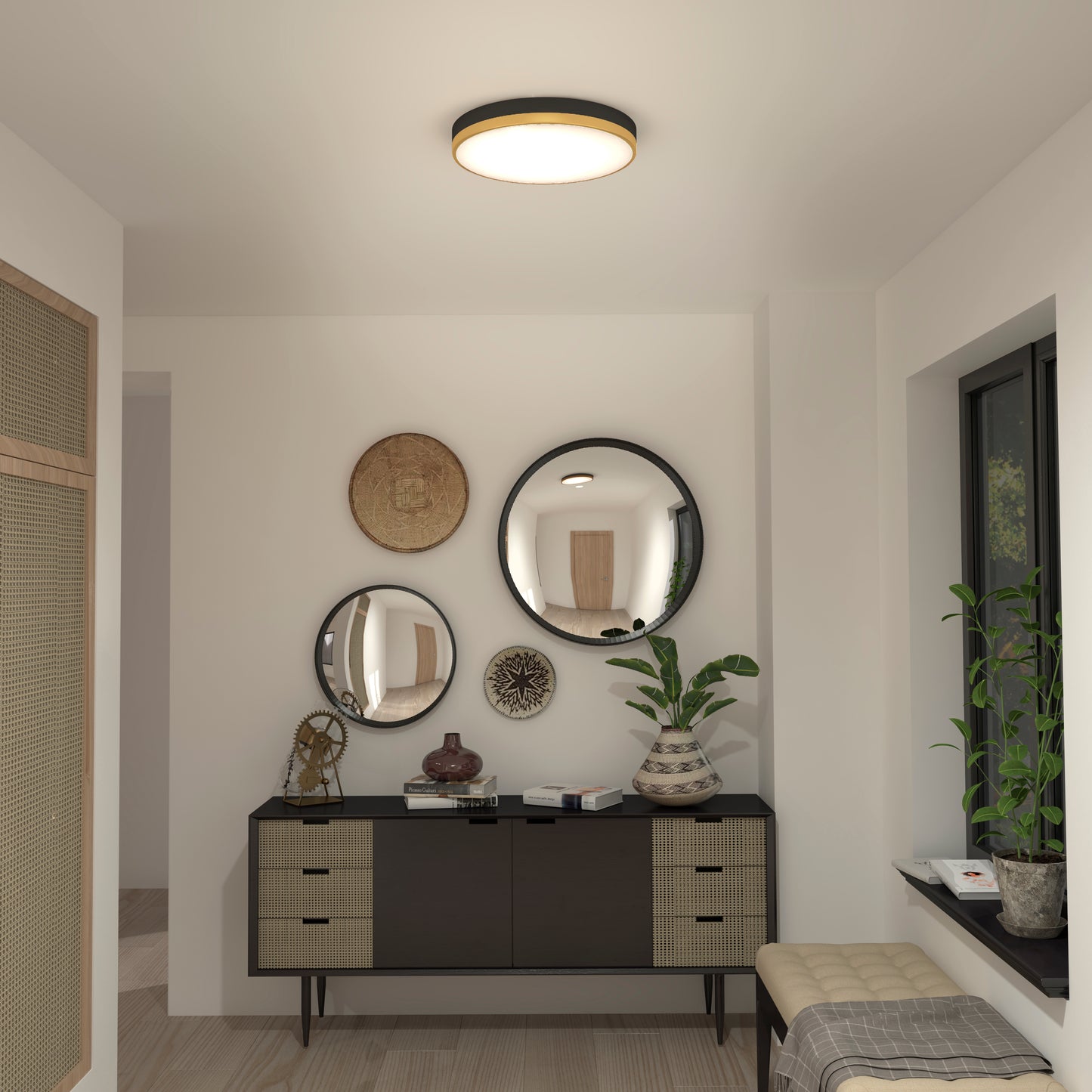 A modern hallway features a black sideboard, three round mirrors, decorative vases, potted plants, and natural light from a window. The Artika Kent LED flush mount light brightens the neutral-toned space from the ceiling.
