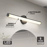 A modern matte black wall-mounted LED light fixture above a mirror, labeled as energy efficient with no bulbs required, and showing a 5-year warranty. Text highlights integrated LED and matte black finish.