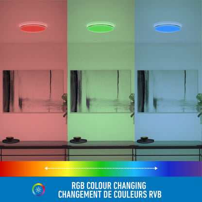 A room features the Artika Macy 15 in. LED modern flush mount light, shown in three sections lit in red, green, and blue. Text below reads: RGB colour changing / Changement de couleurs RVB. Wifi enabled.