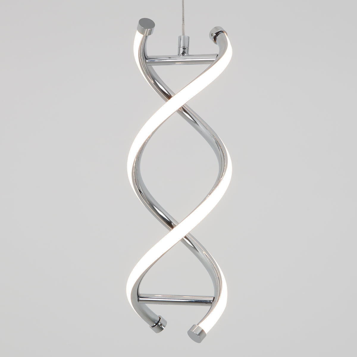 The Artika DNA LED pendant light features two intertwined, helix-shaped chrome strips with integrated LEDs, suspended by a cable against a plain light gray background.