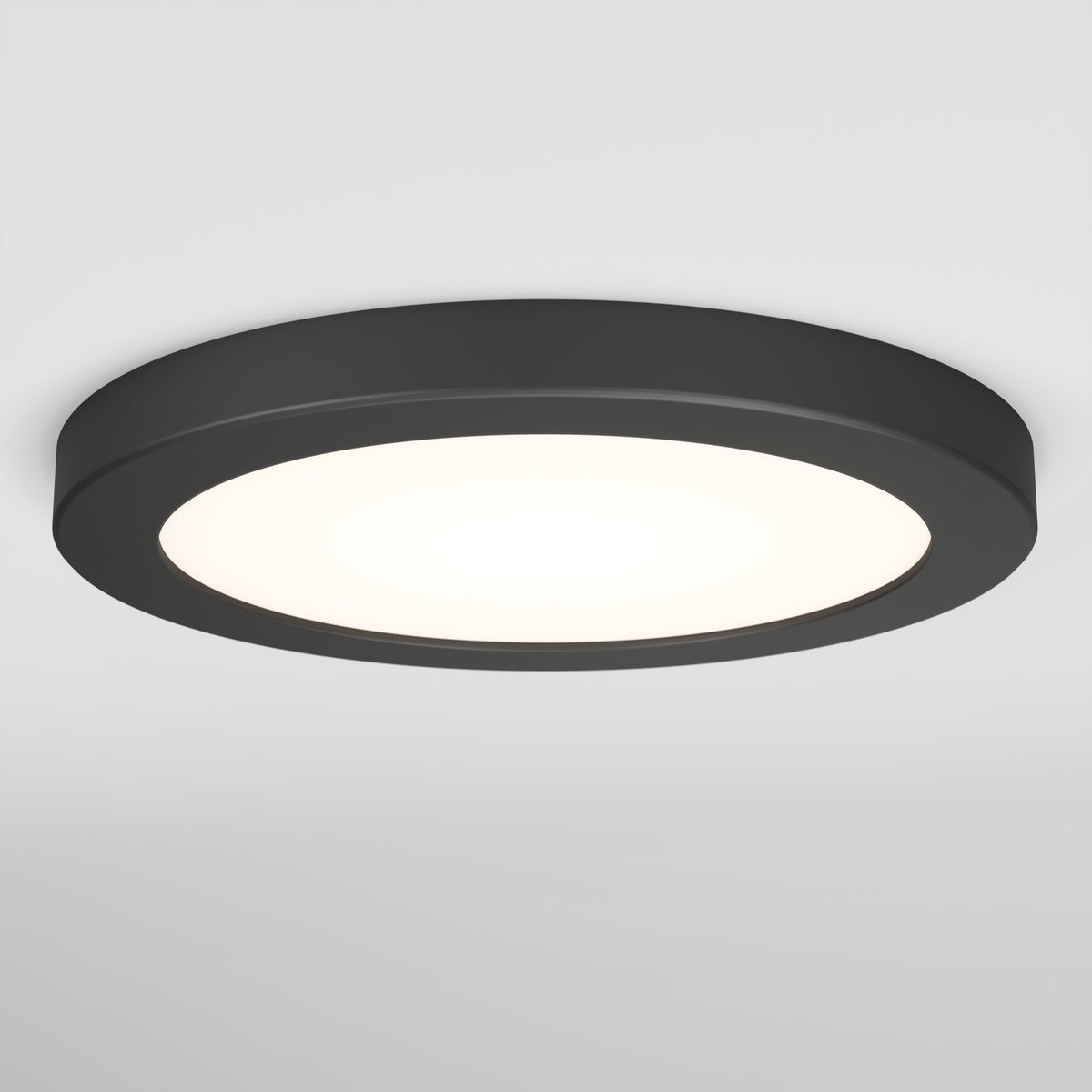 A round, black flush-mounted ceiling light with a white illuminated center, installed on a plain white ceiling.