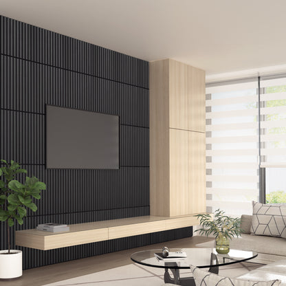 Modern living room with an Artika Sonolok 15.5 ft sound-absorbing wall panel kit as a black textured accent, mounted flat-screen TV, light wood floating cabinet, striped blinds on a large window, indoor plant, and a glass coffee table.
