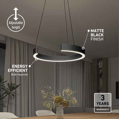 The Artika Vance modern LED pendant light 3 CCT with a matte black finish hangs above a dining table adorned with flowers. Features include adjustable height, energy efficiency, and a 3-year warranty. Room also has curtains and shelves.