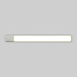 The Artika Outline under cabinet LED light 3CCT is a slim, rectangular fixture with a silver control panel and button on the left side, mounted on a plain light gray wall.