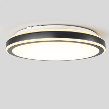The Artika Altitude 15 in. LED modern flush mount light features a black and gold trim, shining brightly against a plain light gray background.