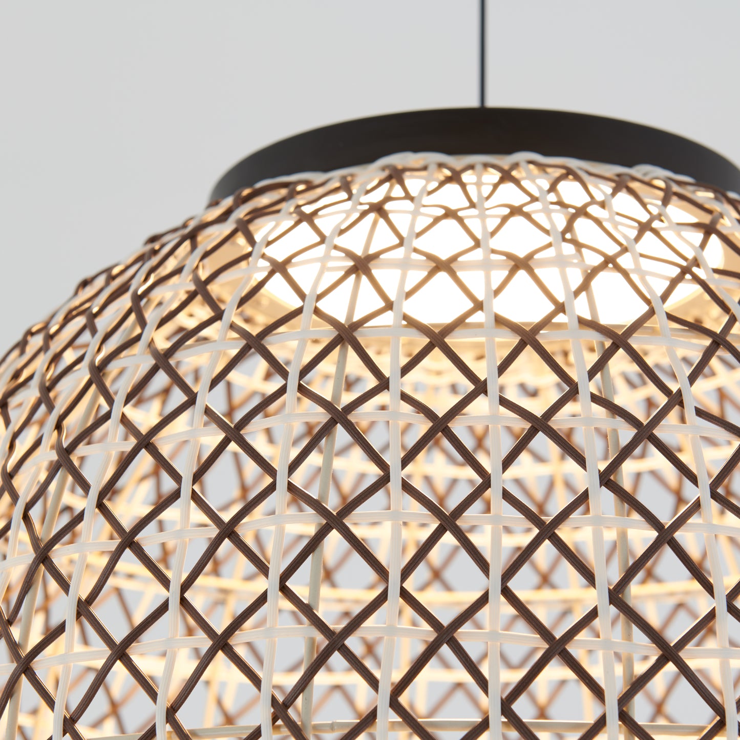 The Artika Benson LED pendant light 5 CCT features a woven rattan shade with a crisscross pattern, illuminated by an LED bulb and hanging from a black cord against a plain light background.
