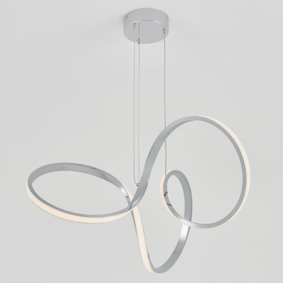 The Artika Swirl LED pendant light features two sleek, intertwined LED loops suspended from thin cables on a polished chrome base, creating a modern look against a plain white background.