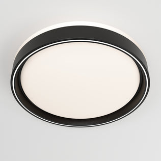 The Artika Callisto 15 in. LED flush mount light features a modern circular design with a black outer ring and white illuminated center, installed on a light gray ceiling.