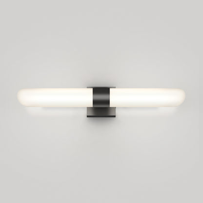 The Artika Wilton LED modern bathroom vanity light 5 CCT features a horizontal, cylindrical frosted glass shade and black rectangular base, offering a soft, even glow ideal for minimalist spaces.
