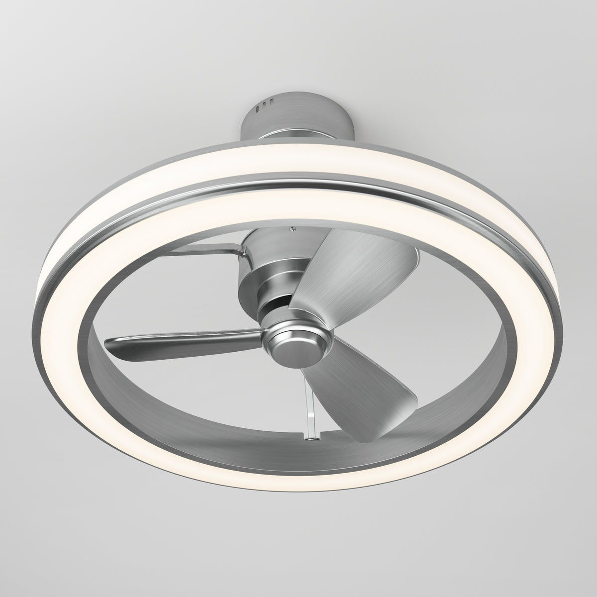 A modern ceiling fan with three metallic blades, enclosed by a circular LED light ring, mounted on a white ceiling.