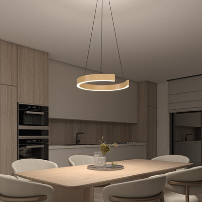 A modern kitchen and dining area with light wood cabinets, built-in black appliances, a round wooden dining table, beige chairs, and a unique spiral pendant light hanging above the table.