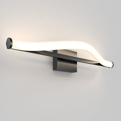 The Artika Arc modern LED bathroom vanity light 5 CCT features a sleek, curved LED bar, a metallic base, and minimalist design, casting a soft white glow against a plain light-colored wall.