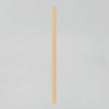 A vertical wooden trim piece with a grooved design stands against a plain white background.