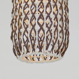 Close-up of Artika’s Benson Mini LED pendant light 5 CCT, featuring a dark brown and off-white crisscross rattan weave with an adjustable color temperature, glowing softly against a plain white background.