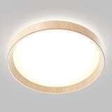 A modern, round ceiling light with a wooden trim and a glowing white center, mounted on a light gray ceiling. The light emits a soft, even illumination.