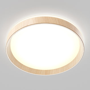 The Artika Callisto 15 in. LED flush mount light features a wooden trim and emits a bright, even white glow, seamlessly mounted on a plain light gray ceiling.