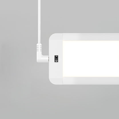 A close-up of the Artika Maestro under cabinet LED light 3CCT, a modern rectangular white fixture suspended by a white cord against a plain light gray background.