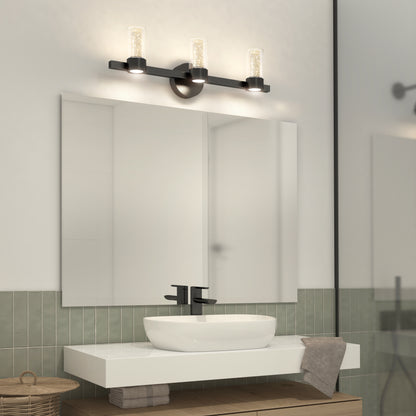 Modern bathroom featuring a rectangular mirror above a white floating sink with black faucet, green tile backsplash, wicker basket, and the Artika Novello modern LED bathroom vanity light.