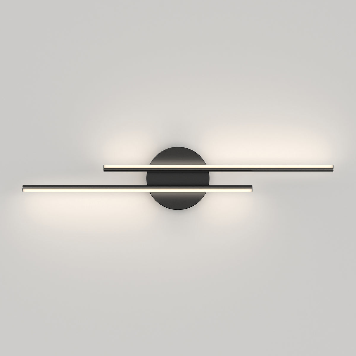A modern wall light fixture with two slim, horizontal LED bars intersecting at a central, circular black base, casting soft illumination on a plain white wall.
