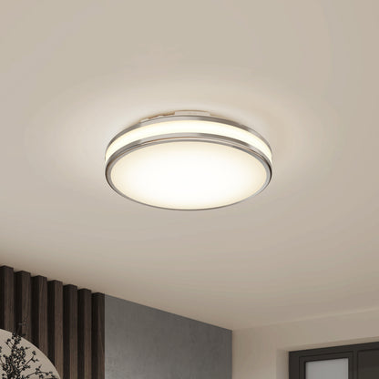 The Artika Hemisphere 15 in. LED flush mount light features a frosted white cover, subtle metallic accents, and adjustable brightness. Ideal for bathrooms, this modern fixture mounts on a white ceiling and offers 5 CCT color options.