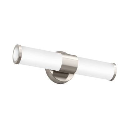 The Artika Adina modern bathroom vanity light 3 CCT features a wall-mounted design with a cylindrical white shade, metallic accents on both ends, and a round metallic base for contemporary style.